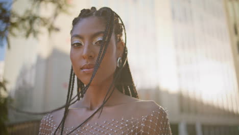 braids girl posing windy street portrait. dreadlocks woman looking camera