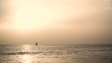 solitary sailboat at sunset