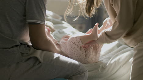 loving couple taking care of their baby at home