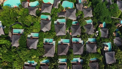 top-down aerial view of luxury villas with private pools surrounded by lush greenery on koh samui, thailand. geometric composition, tropical vibes, ideal for travel, real estate, and architecture