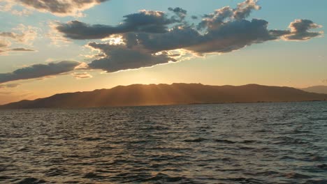 beautiful sunset view of the ocean and serra de montsia mountains from ebro delta catalonia spain - wide shot