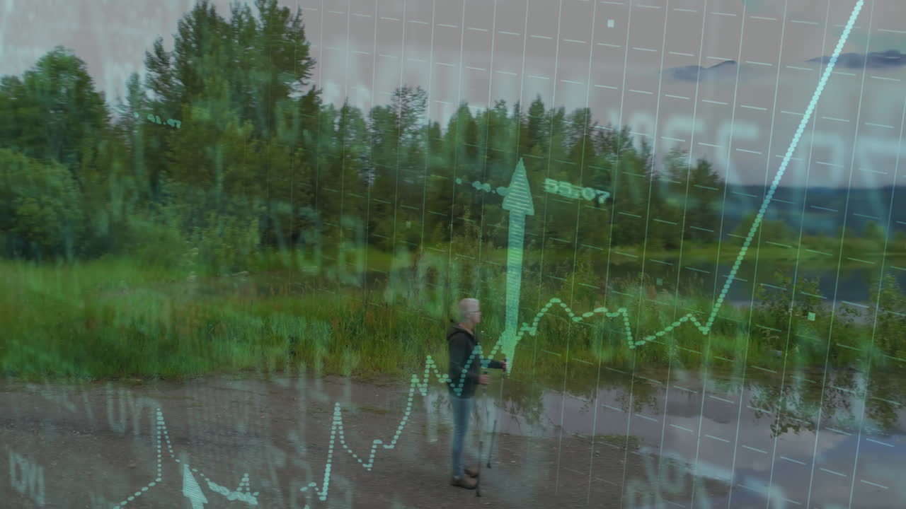 senior hiker walking muddy trail beside calm river showing trekking poles and finance graph overlay