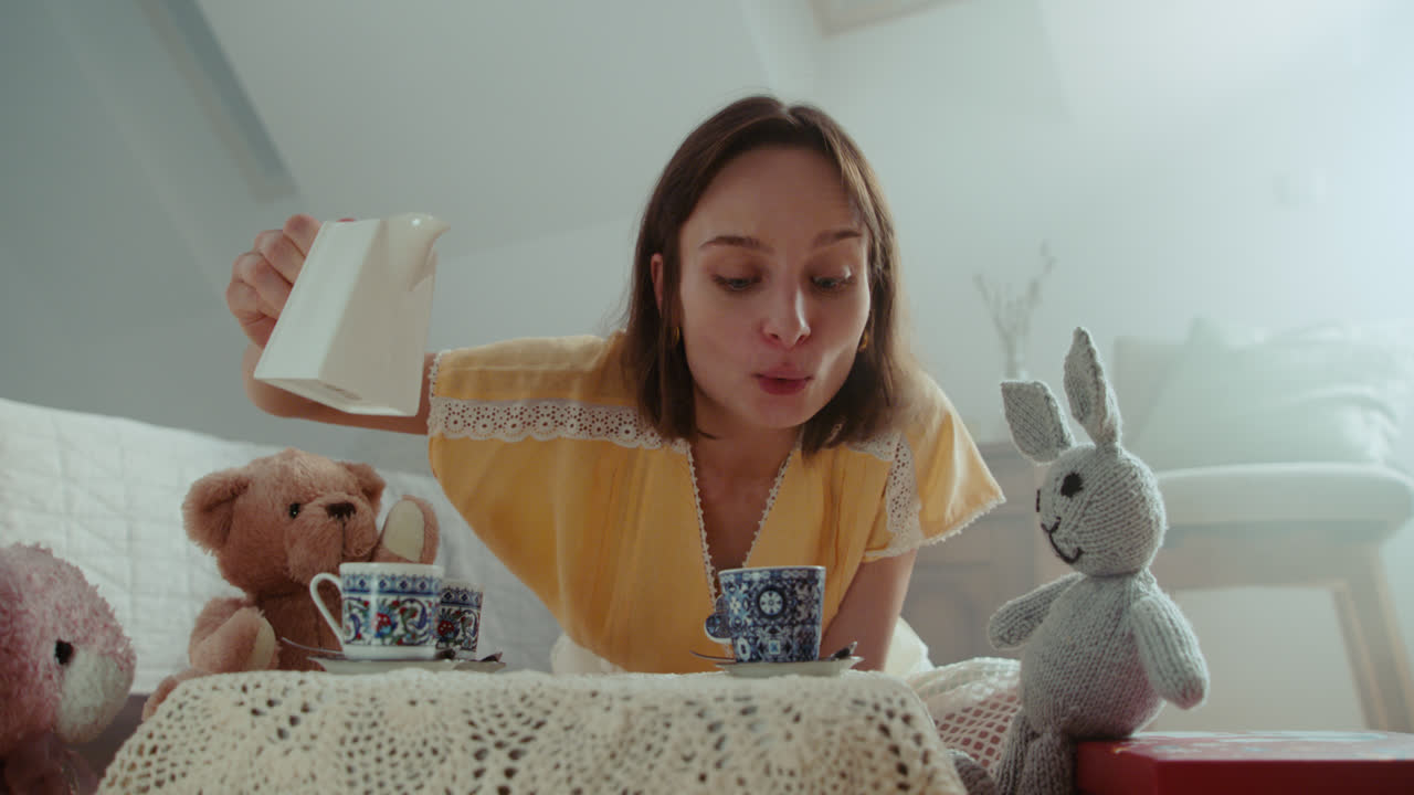 A girl playing with dolls in her room