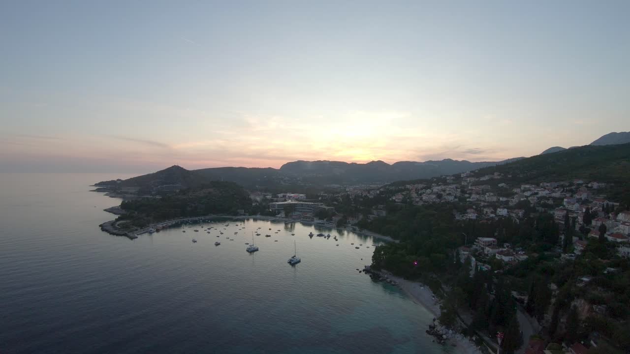 Aerial Drone Footage of an Early Sunrise over the Bay with Boats of Serbreno, Croatia.