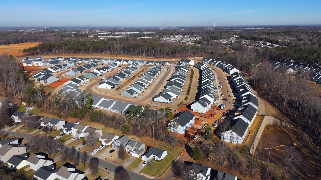 Aerial View Of Modern Suburban Housing Development Under Construction On Sunny Day In The USA.