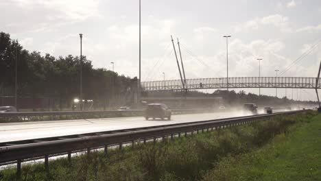 Cars-driving-on-a-wet-highway,-shortly-after-rain