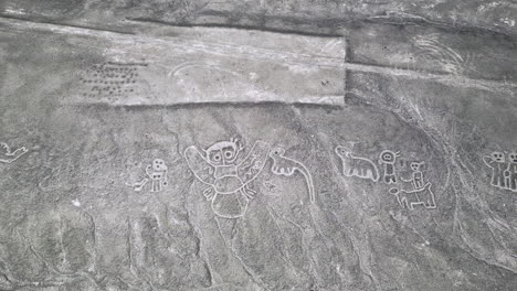 top down aerial above humanoid creatures geoglyphs in the nazca desert, peru