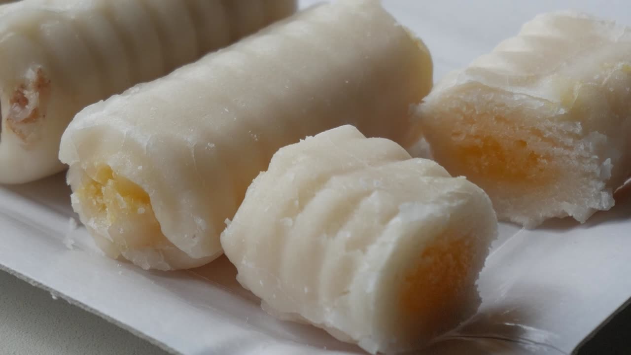 Tasty marzipan rolls close up with filling traditional for All Saints day in spain, Huesos de Santo