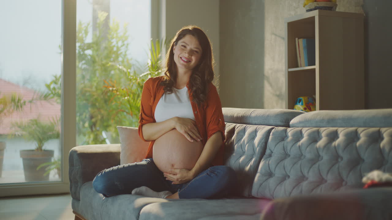 Pregnant Woman Relaxing on Sofa