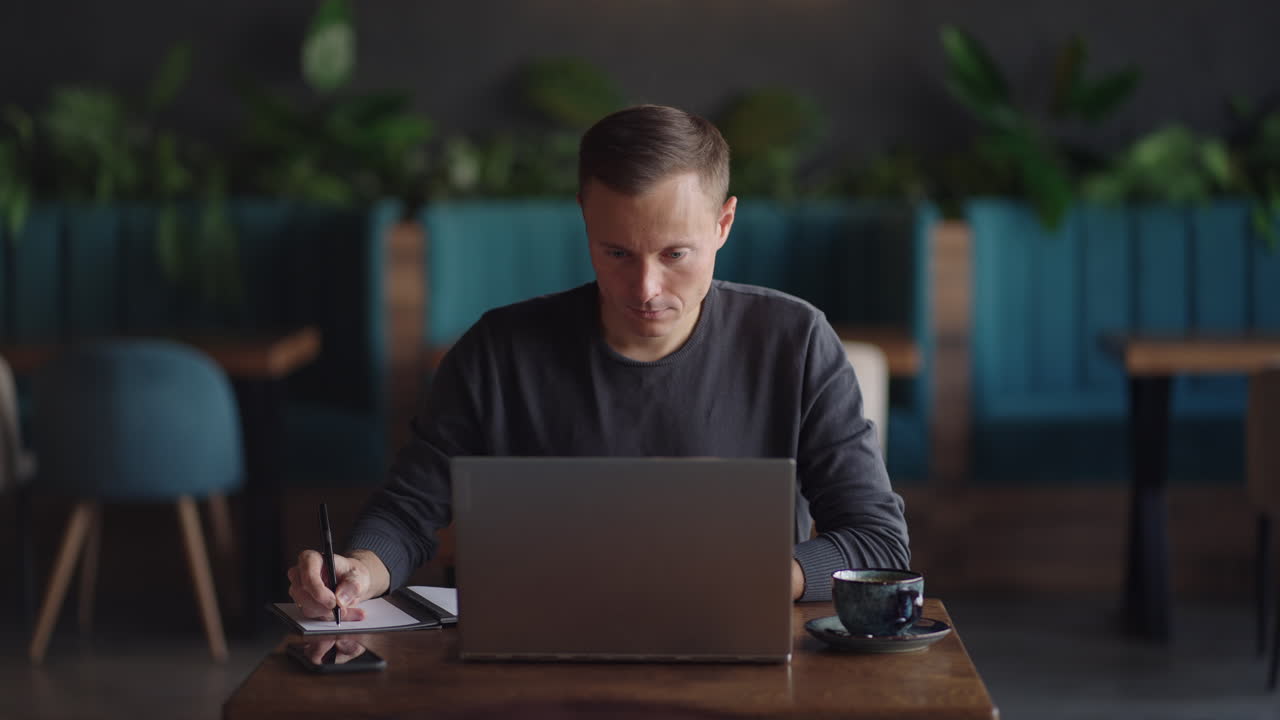 Hispanic latin man college student using laptop computer watching distance online learning seminar class remote university webinar or having virtual classroom meeting in university creative space.