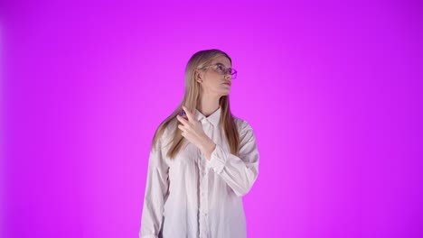 Confident-young-woman-applies-cologne-on-neck,-looking-at-camera,-studio-shot