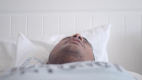 man sleeping in bed