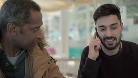 Smiling-men-talking-and-working-together