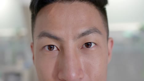 Portrait-of-happy-asian-male-nurse-looking-at-camera-at-hospital,-in-slow-motion