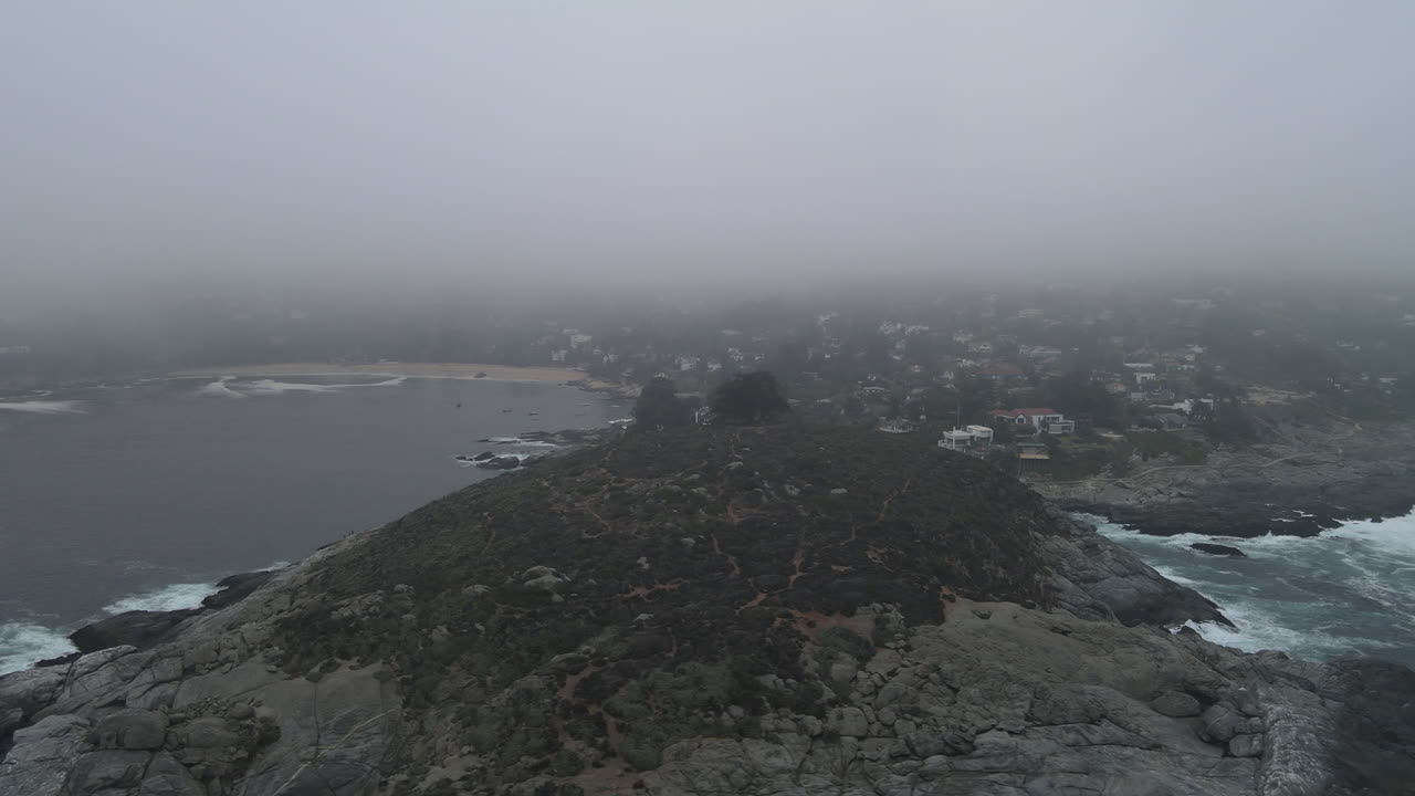 AERIAL - Foggy Cerro de la Cruz, Zapallar, Valparaiso, Chile, wide circle shot