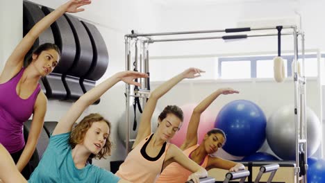 Beautiful-women-exercising-in-fitness-studio