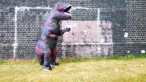 happy funny prehistoric dinosaur spraying bubbles against brick wall