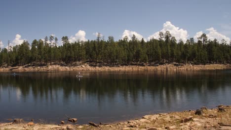 white paddleboard passes by on willow spring in the usa southwest