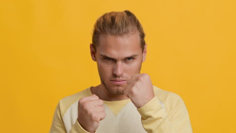 man with clenched fists, aggressive expression