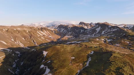 drone sideways majestic mountain range in iceland on a sunny summer day, blue sky