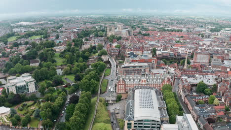 Descending-drone-shot-looking-towards-York-Minster-Cathedral-over-city-wall-cloudy-day