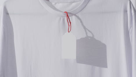 video de camiseta blanca con etiqueta y espacio de copia en fondo blanco