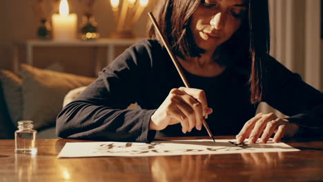woman practicing calligraphy at home