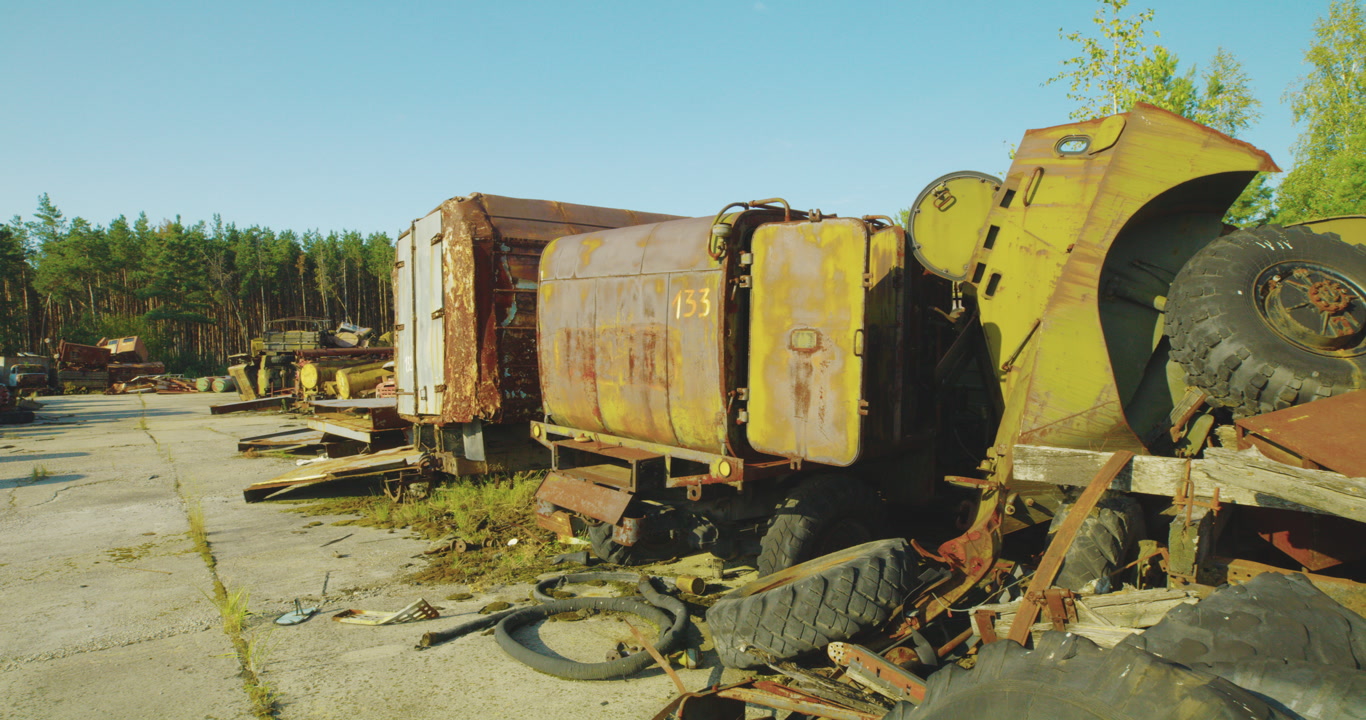 Static shot of Industrial vehicles in a desolate junkyard