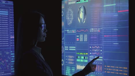 the woman working on sensor display in the dark laboratory