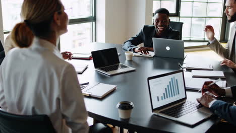 diverse business team collaborates and discusses strategy in a modern office meeting
