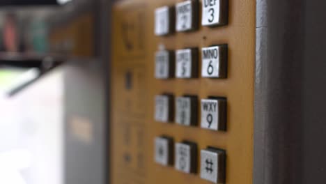 closeup of public phone buttons. focus is on the right.