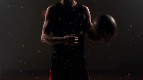 animation of moving spots over caucasian male basketball player holding basketball