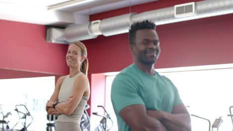 fit young caucasian woman and african american man at the gym