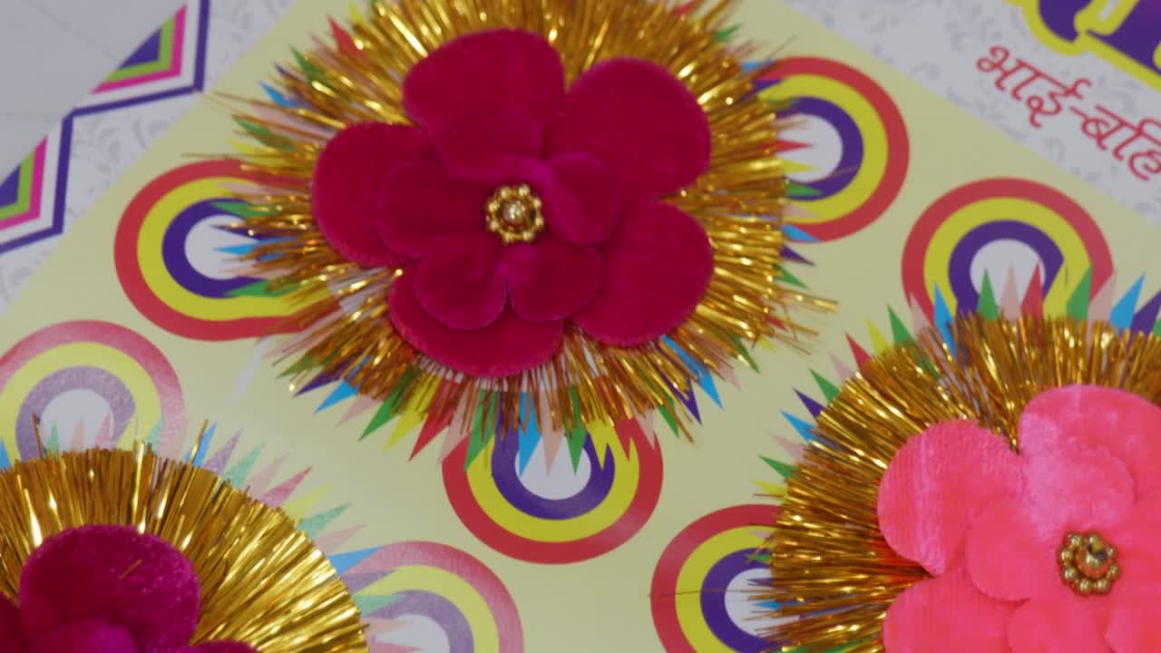 Flower-Shaped Rakhis, with shimmering gold tinsel, and velvet base, for Raksha Bandhan Festival in India , 4k, closeup, 25p