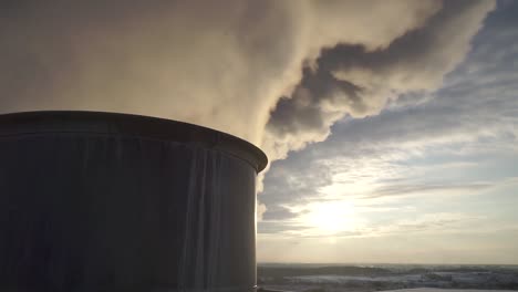 Close-up-shot-of-smoke-go-trough-the-industry-pipe-on-front-of-the-sunset