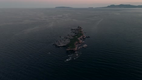 rocky island of ile plate - flat island near the pointe saint-pierre by the gulf of saint lawrence in quebec, canada on a sunrise