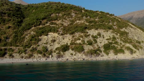 Coastline-of-Ionian-sea-with-blue-azure-water-washing-rocky-slopes-of-mountains-in-Albania