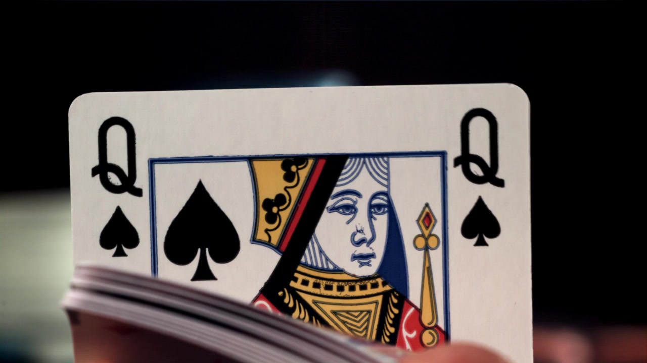 Close-up of a Hand Fanning Through a Deck of Playing Cards