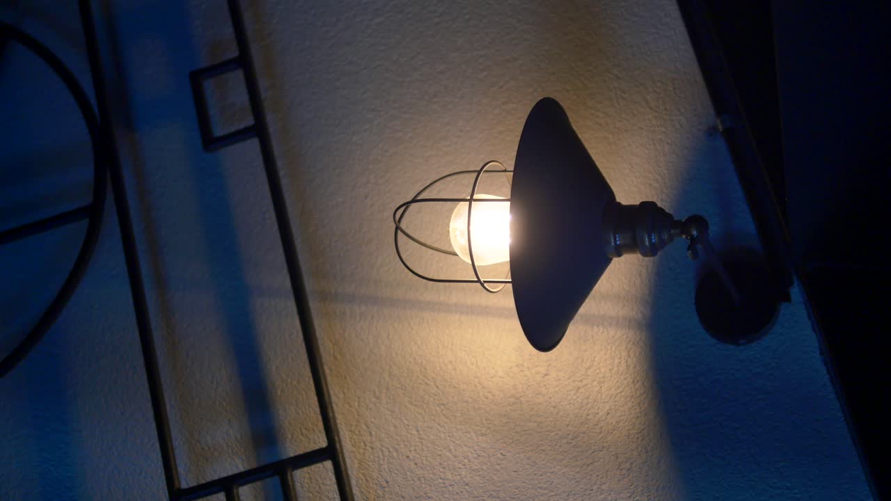 Industrial Style Wall Lamp Illuminating a Wall