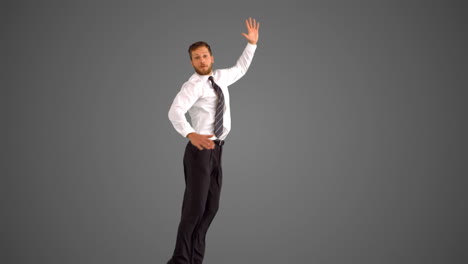 Businessman-leaping-up-and-grabbing-legs-on-grey-background