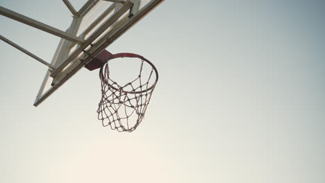 close up of outdoor basketball hoop in a sunny day