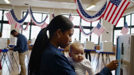 woman holding a baby at a polling place