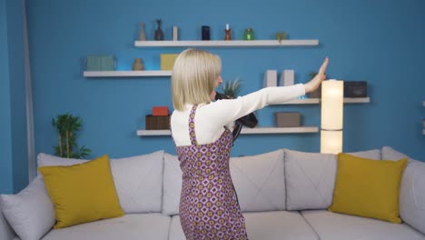 Woman-singing-to-the-hair-dryer.-He-is-dancing-and-having-fun.