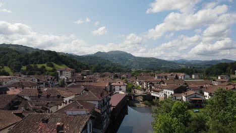 Drone-take-off,-rising-shot-over-the-Bidasoa-River,-in-a-charming-little-town-of-Elizondo-in-the-Baztan-Valley