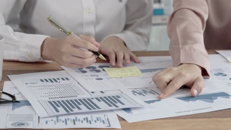 primer plano dos jóvenes mujeres de negocios entusiastas trabajando en la oficina con papel de informe.