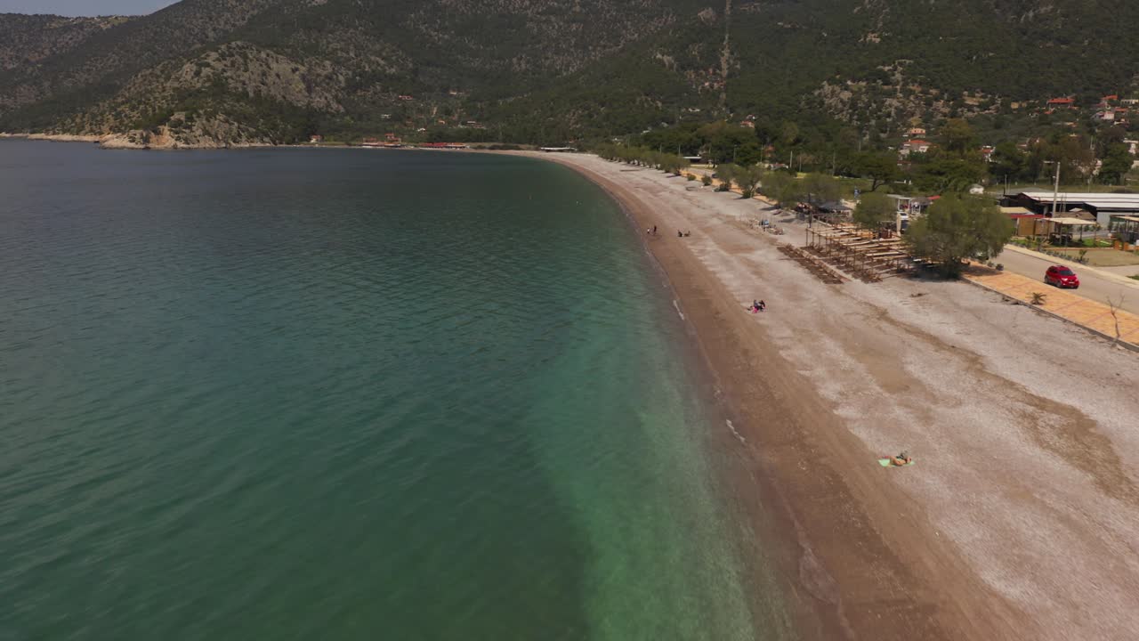 An aerial view of a beach in blue sea in Greece