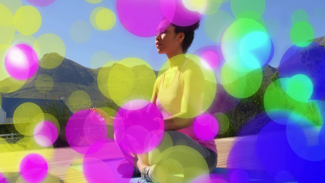 Woman meditating on yoga mat, camera panning starting bokeh overlay obscuring her for wellness