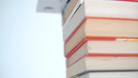 A-stack-of-books-with-colourful-covers-is-on-the-table