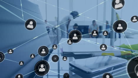 Animation-of-network-of-connections-with-icons-over-diverse-businesspeople-in-office