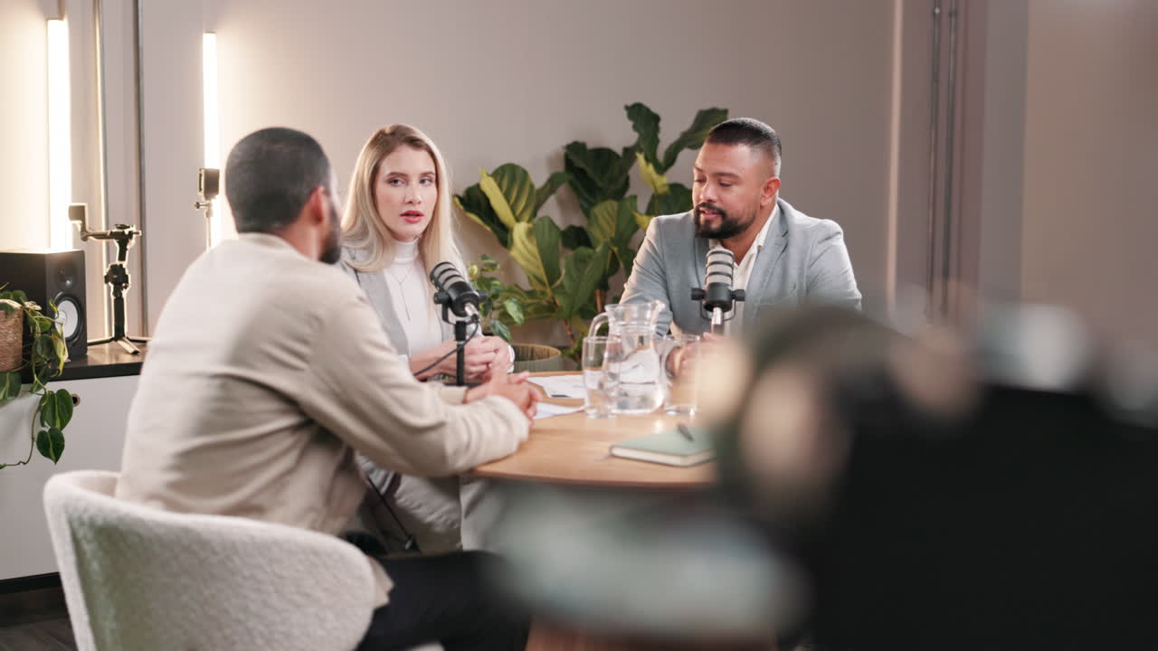 Podcast studio with three people at a table